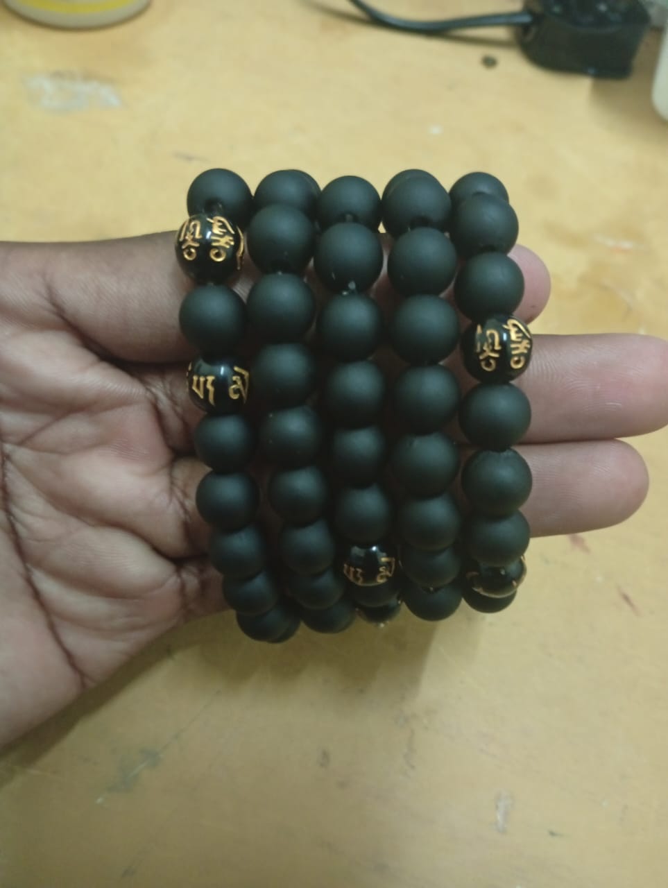 Black Matte Onyx Bracelet with Gold Mantra Beads - Image 2